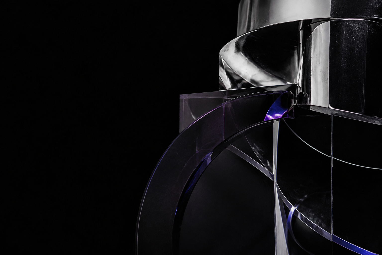 Abstract chrome and smoked acrylic forms illuminated in violet